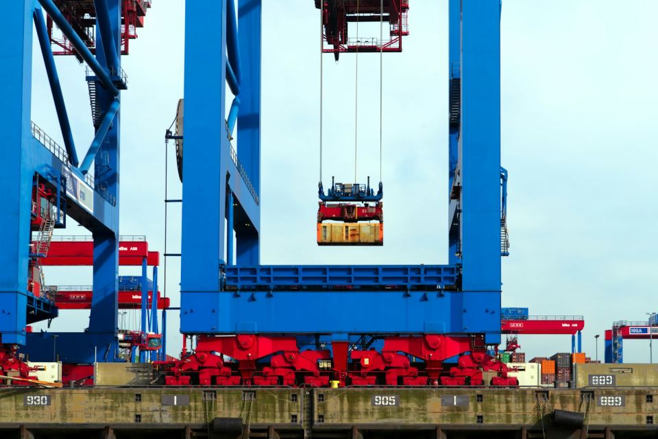 A ship-to-shore gantry crane lifting a container over the quay