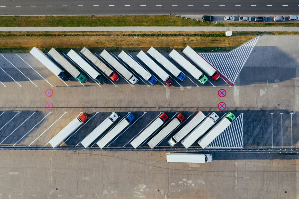 A depot of curtain-side trailers seen from above
